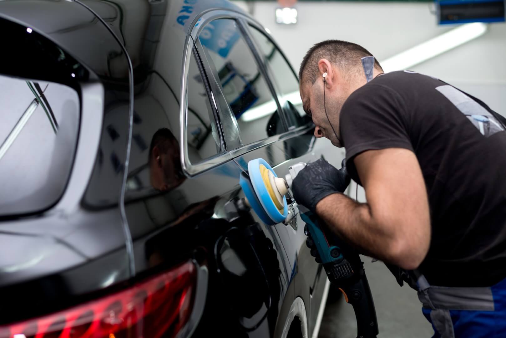 Car detailing expert from York waxing a car.